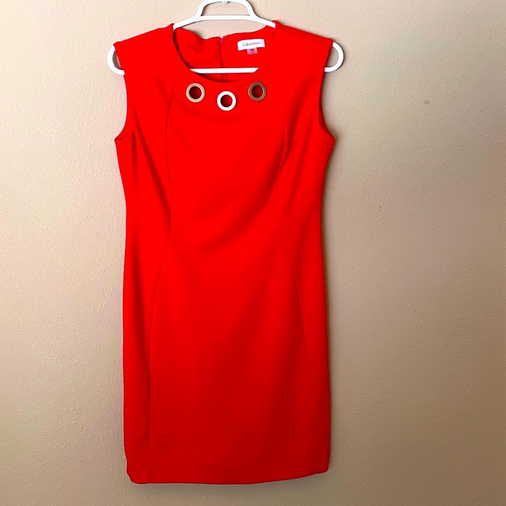 Calvin Klein. Size 6. Red dress with round gold hardware.